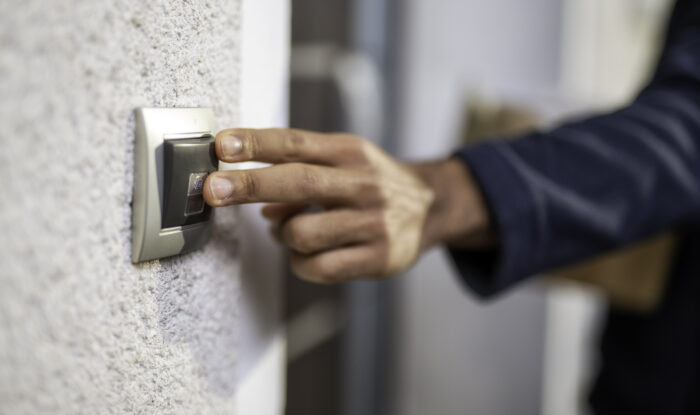 fingers on a doorbell