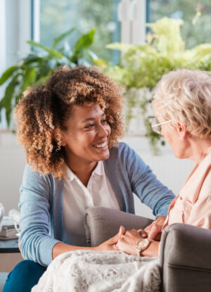 friendly nurse supporting an eldery lady