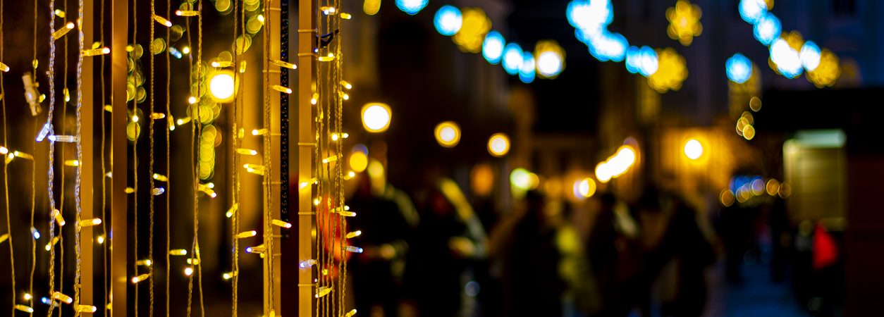 colorful christmas lights with blurred street lights in the background at night