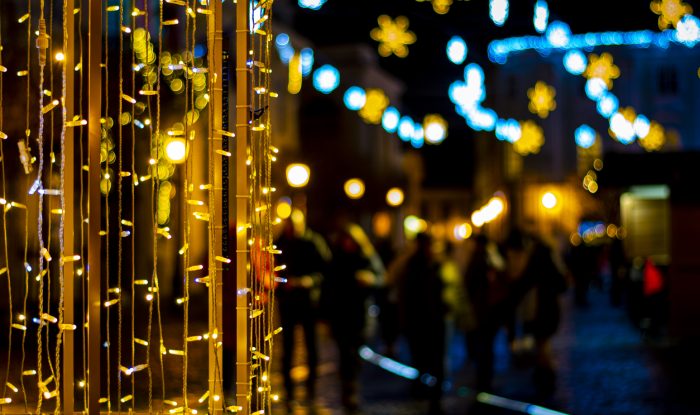 colorful christmas lights with blurred street lights in the background at night