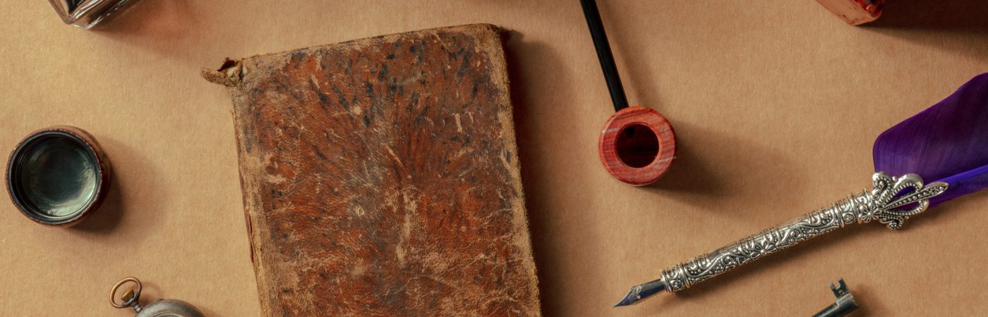 vintage pipe, notebook, watch and key. private detective investigation