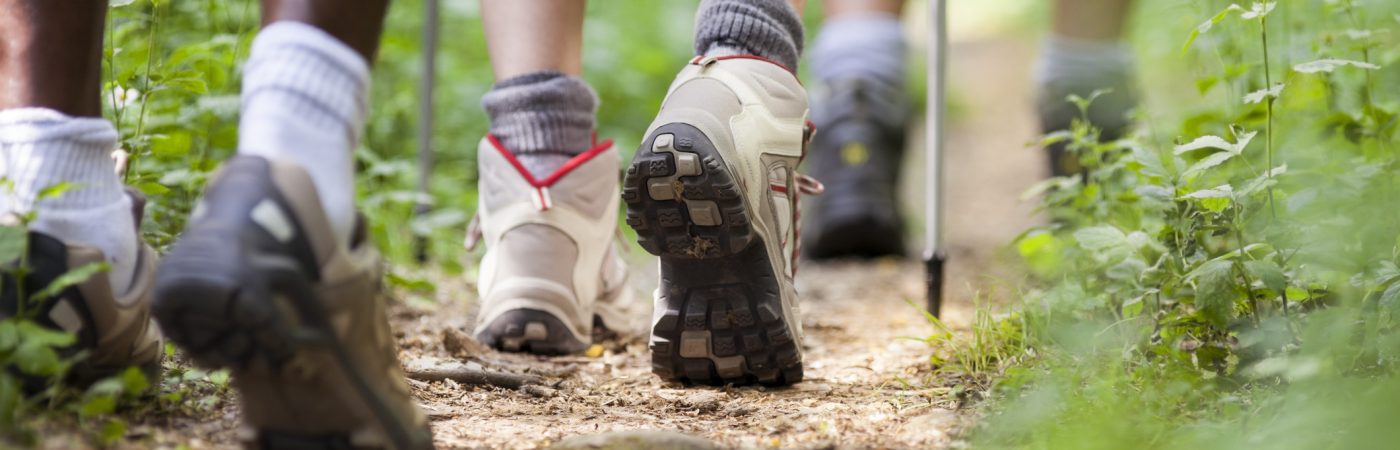shoes of people trekking and walking in row