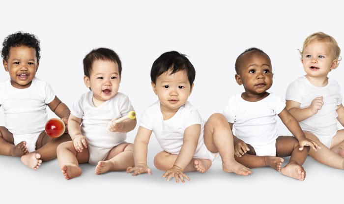 diverse babies sitting on the floor