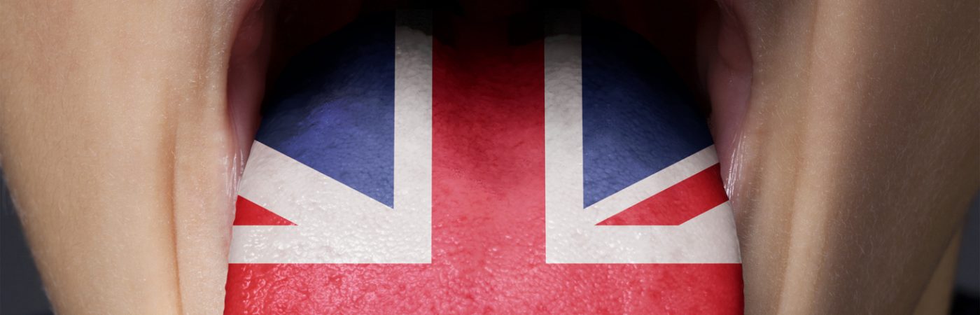 english language. great britain uk flag painted in tongue of a child.