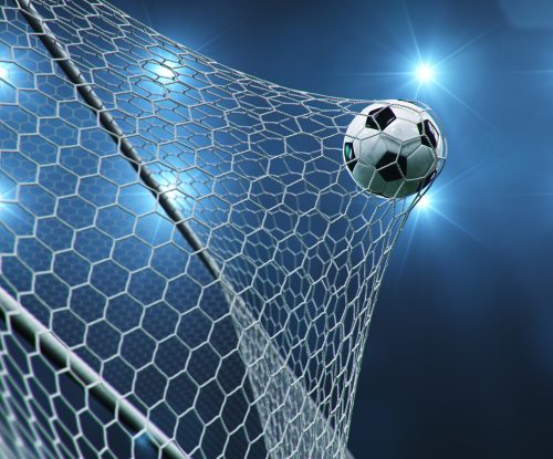 soccer ball flew into the goal. soccer ball bends the net, against the background of flashes of light. soccer ball in goal net on blue background. a moment of delight. 3d illustration