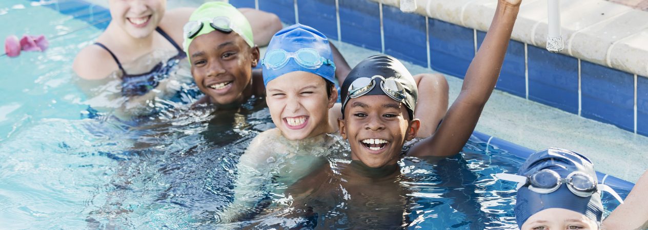 multi ethnic children on swim team in pool