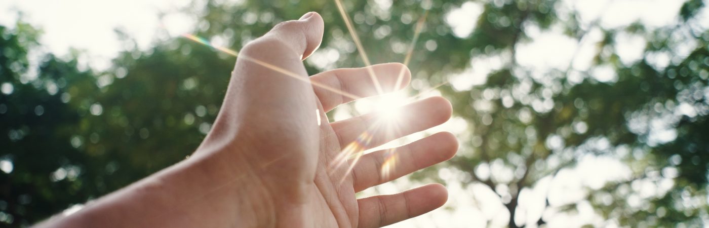 hand touching sunlight.