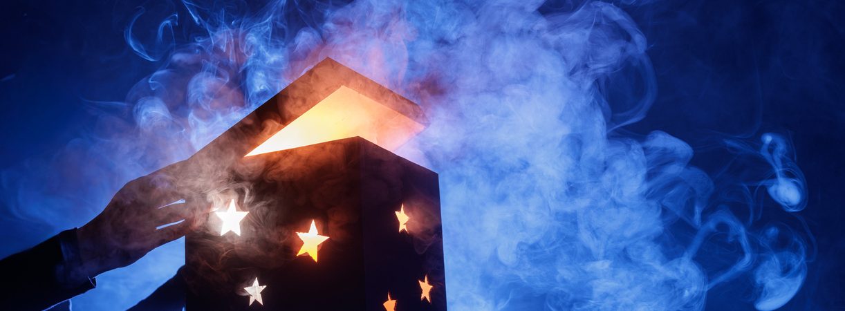 glowing magic mystery box opening with smoke and stars on blue background